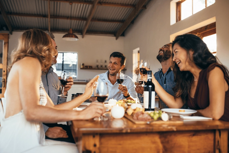 residents eating together and drinking wine in a co-living space